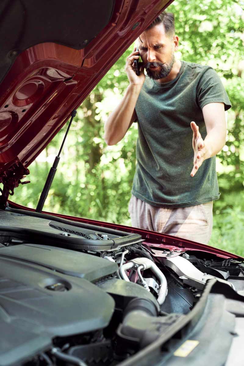 Junger Mann prüft Getriebeschaden bei Schrottauto Ankauf Mülheim